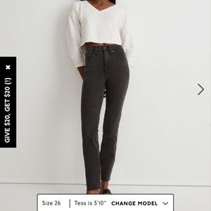 11" High-Rise Skinny Jeans in a black with distressed hem.